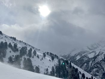 Scenic view of snowcapped mountains against sky