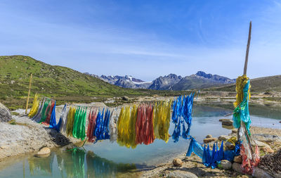 Clothes drying on rope over river against mountains