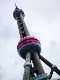 Low angle view of tower against cloudy sky