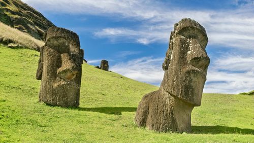 Rock formations on field against sky