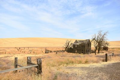Abandoned barn on landscape against sky