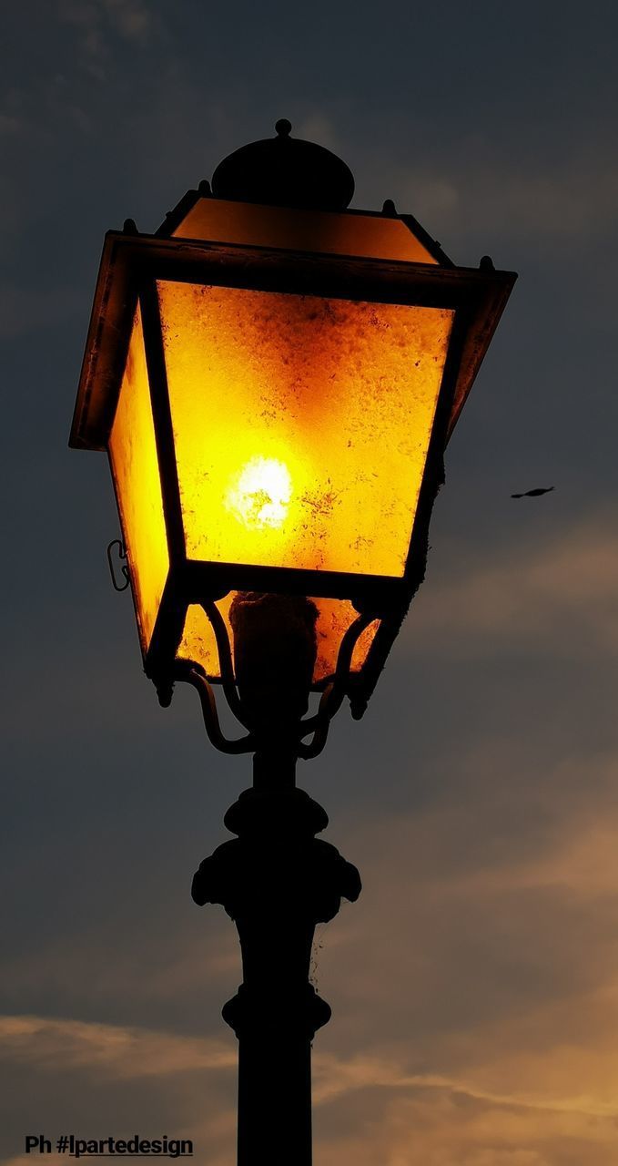 LOW ANGLE VIEW OF STREET LIGHT AGAINST ORANGE SKY