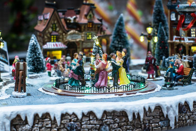 Close-up of figurine against buildings,christmas property