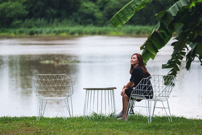 Portrait image of a beautiful asian woman sitting in the yard by the river