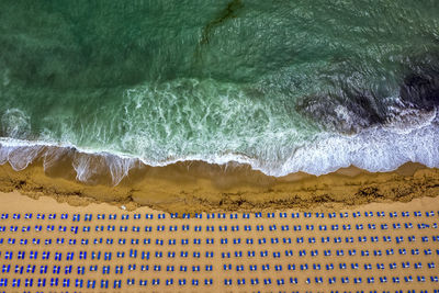 Aerial view of deck chairs arranged on beach
