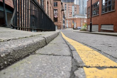 Surface level of road by buildings in city