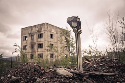 Low angle view of old building against cloudy sky