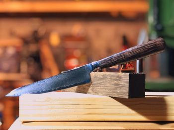 Close-up of knife on wood