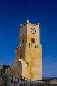 Low angle view of tower against clear blue sky