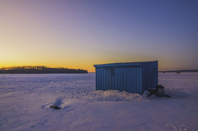 Scenic view of snow against clear sky during sunset