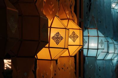 Low angle view of illuminated lanterns hanging in building