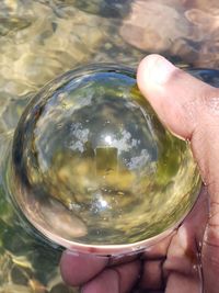 Midsection of person holding glass