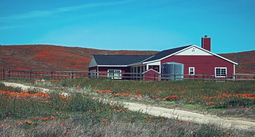 Houses on field against sky