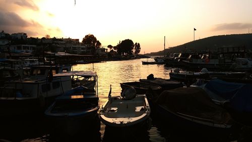 Boats in river at sunset