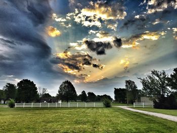 Soccer field against sky during sunset