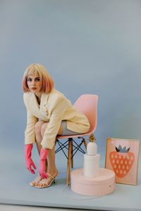 Portrait of young woman sitting on chair