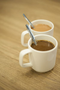 Close-up of tea and coffee cups on table