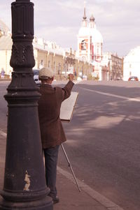 Rear view of road surveyor at city street