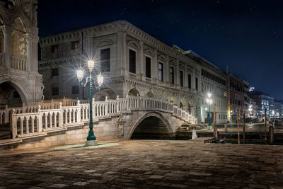 Illuminated street lights and building at night