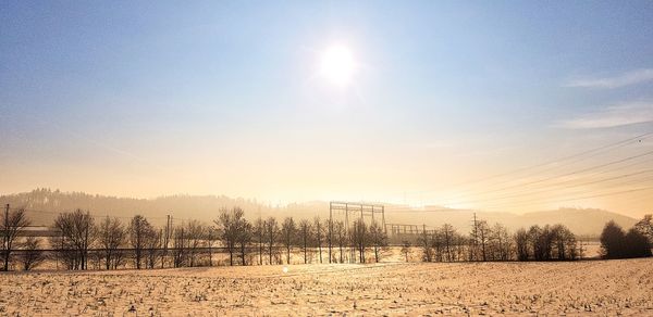 Scenic view of field against sky during winter