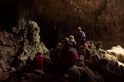 People sitting in cave