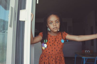 Portrait of girl standing at doorway