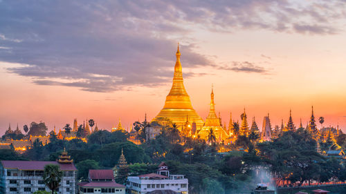 Temple building against sky during sunset