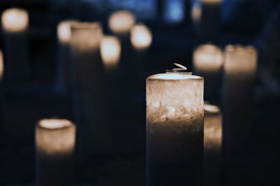 Close-up of illuminated candles in temple