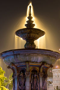 Statue by water against sky