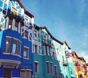 Low angle view of residential building against blue sky