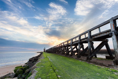 Bridge over sea against sky