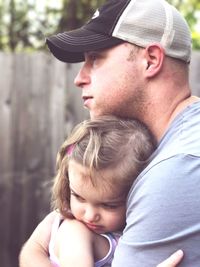 Close-up of father embracing daughter at yard