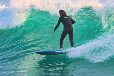 Full length of man surfing in sea