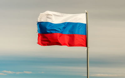 Low angle view of flag against the sky