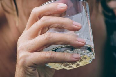 Close-up of hands holding glass