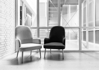 Rear view of woman sitting on chair at home