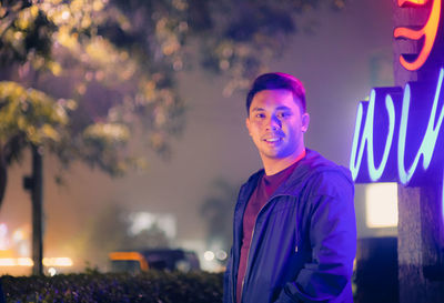 Portrait of young man standing outdoors