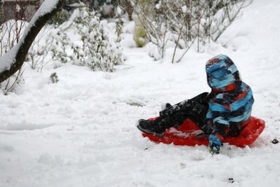 Boy on snow field during winter