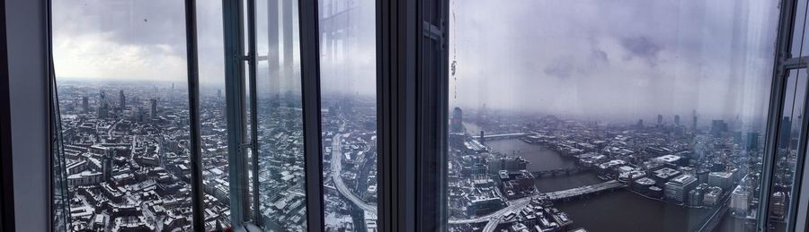 High angle view of buildings seen through glass window