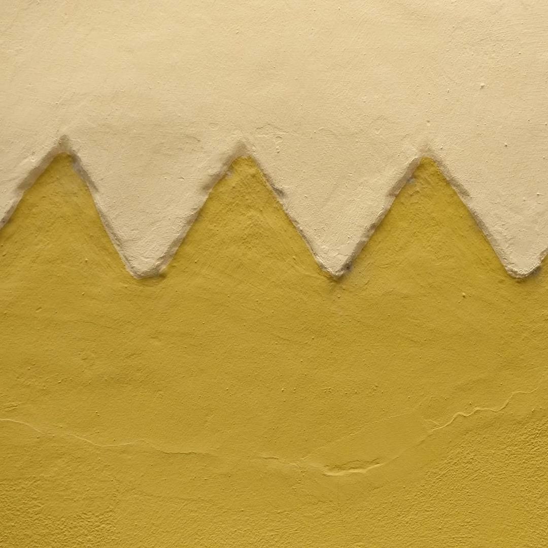 CLOSE-UP OF YELLOW WALL WITH TEXT