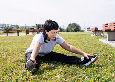Young man sitting on field
