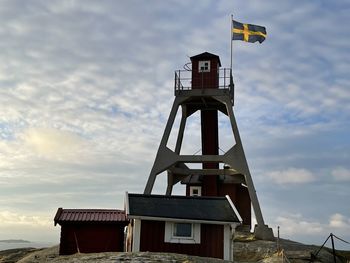 Low angle view of lighthouse on building against sky