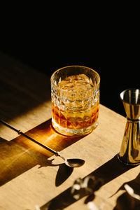 Close-up of glass with bourbon whiskey on table