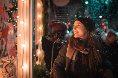 Woman looking at store window during christmas