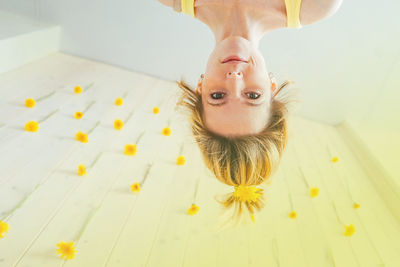 Portrait of young woman lying on bed at home