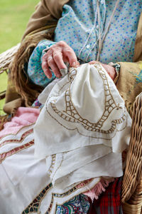 Midsection of woman sewing textile