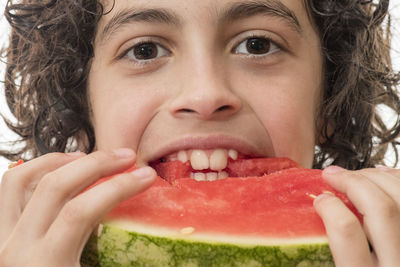 Close-up portrait of young man eating watermelon