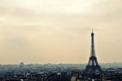 Tower in city against sky