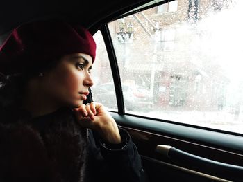 Woman looking through window