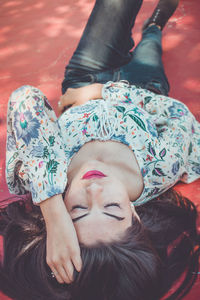 High angle view of woman lying on floor